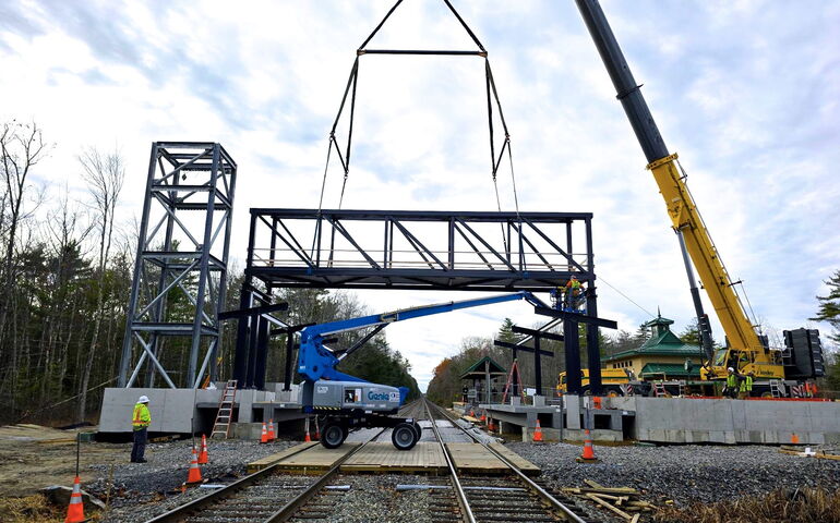 Heavy machinery works on a rail line.