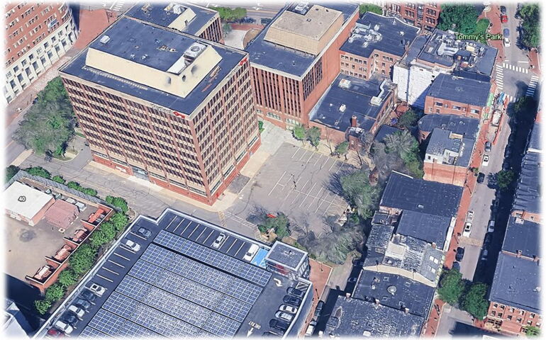 An aerial view of buildings and a parking lot.