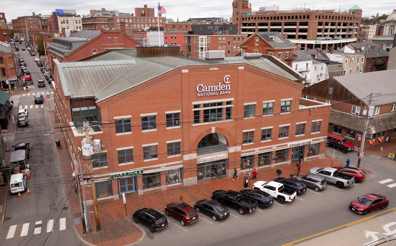 An aerial view shows a multi-story brick building.