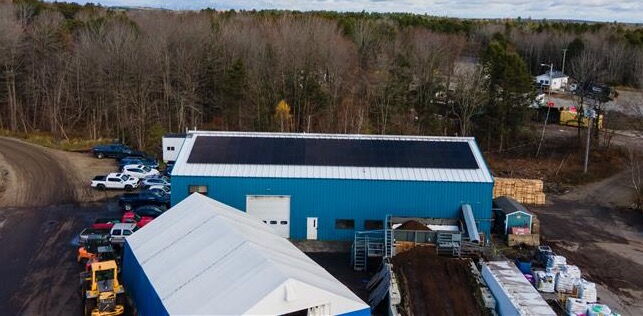 aerial view of a manufacturing plant with solar roof panels