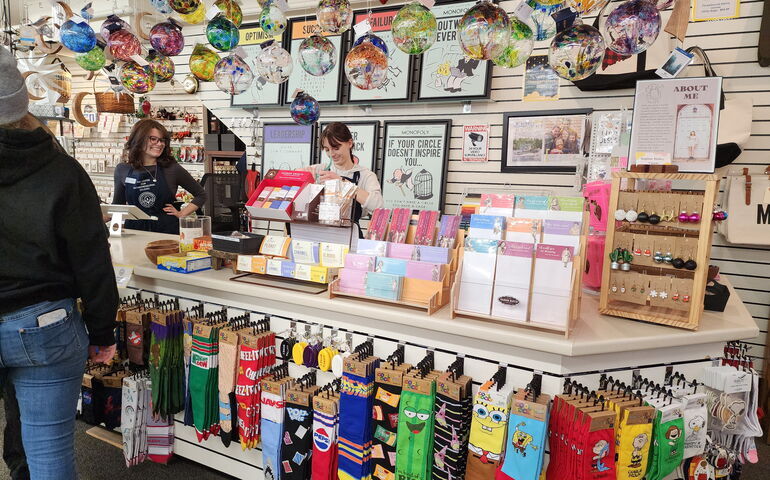 People are at the counter of a store.