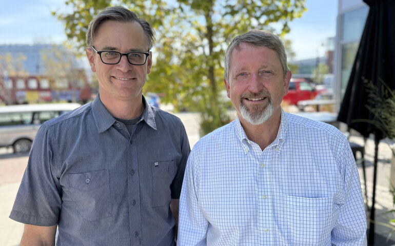 Two people pose for a photo.