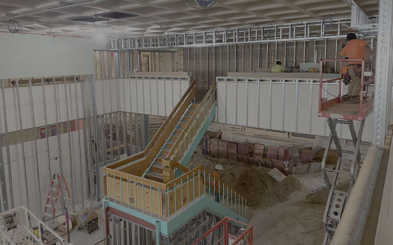 An intervior view has a staircase under construction