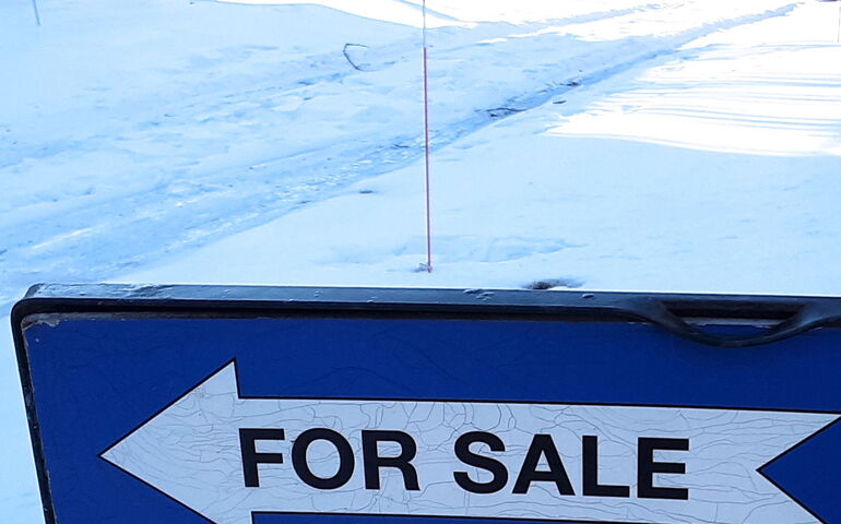 A sign has snow around it.