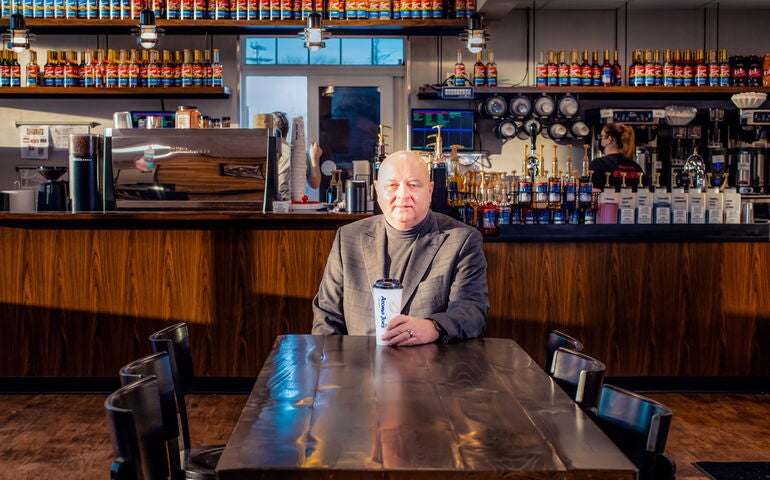 Loren Goodridge seated in an Aroma Joe's coffee house