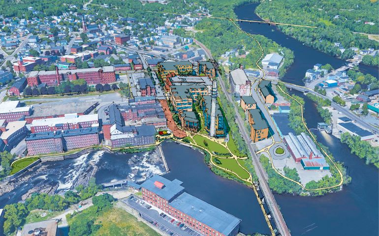 an aerial photo of several brick mill complexes surrounded by rivers with a rendering of a more modern complex among them