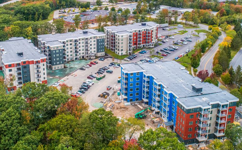 aerial view of four six-story buildings under construction