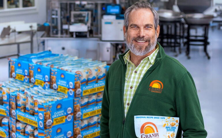 Man holding food product in a factory.