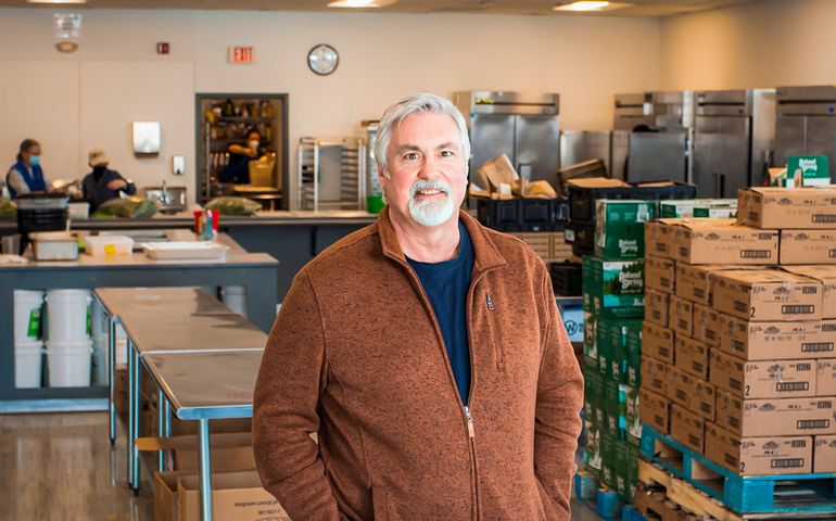 middle-aged man standing in industrial kitchen