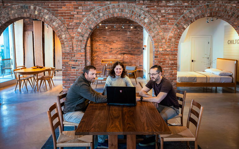 Jen Levin</b>, president and owner of <b>Chilton Furniture</b>, meets with showroom manager  <b>Zac Brubach</b>, left, and <b>Adam Goldberg</b>, a sales floor team member, at the Portland store.