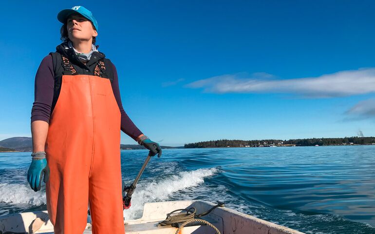 Oyster fisherwoman on a boat