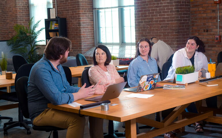 4 people sitting at a table