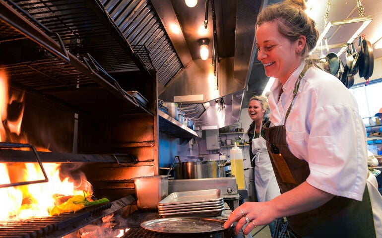 kitchen worker at commercial stove