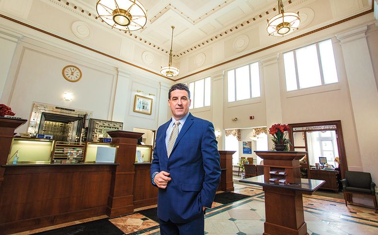 Bob Montgomery-Rice, president and CEO of Bangor Savings Bank, inside a bank building.