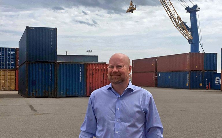 Jonathan Nass at IMT with cranes and containers in the background 