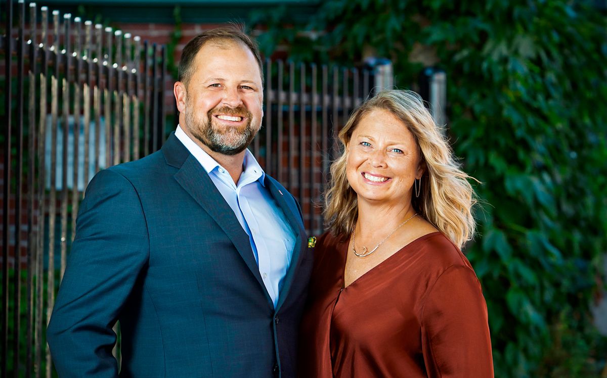 man and woman standing and smiling