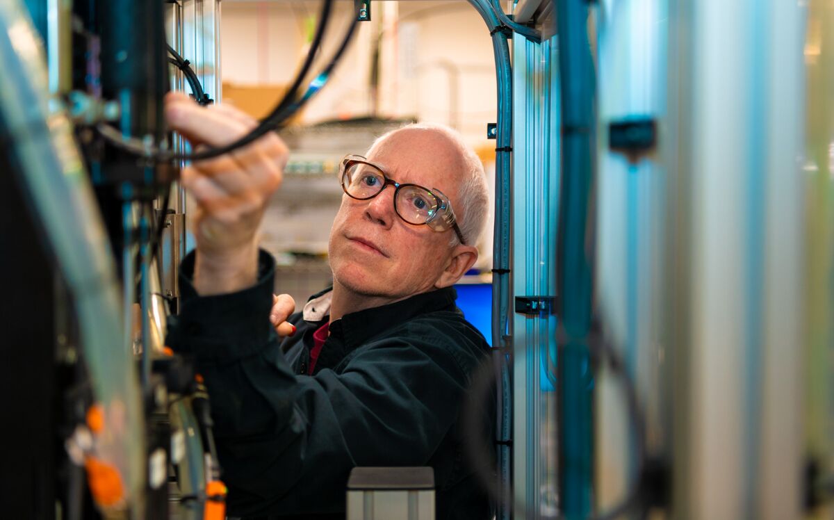 man adjusting industrial machine